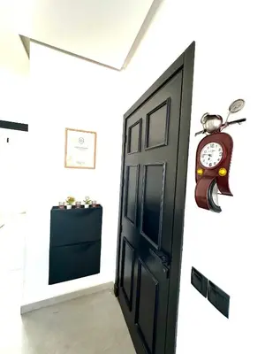 a clock on a wall next to a door at Alonso studio au coeur de Maarif in Casablanca