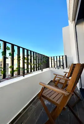 a wooden chair sitting on top of a balcony at Alonso studio au coeur de Maarif in Casablanca