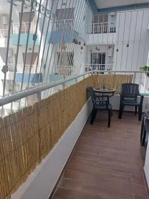 a balcony with two chairs and a table on a ship at Apparemment 300 m de la plage, Parc Mohammedia in Mohammedia