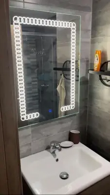 a bathroom with a sink and a mirror at Apparemment 300 m de la plage, Parc Mohammedia in Mohammedia