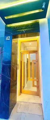 a front door of a building with a window at Joli cocon en plein centre a10 min a pieds de la corniche in Casablanca
