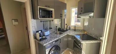 a kitchen with a sink and a washing machine at The 23 Princesses by IB Signature - Stylish 2 Bedroom Apt with Wifi, Self check-in - 24 x7 Security - City View - Walk to Cafes! City Centre in Casablanca