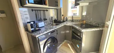 a kitchen with a washing machine and a sink at The 23 Princesses by IB Signature - Stylish 2 Bedroom Apt with Wifi, Self check-in - 24 x7 Security - City View - Walk to Cafes! City Centre in Casablanca