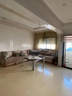a living room with a couch and a coffee table at Appartement Oasis Beach in Mohammedia