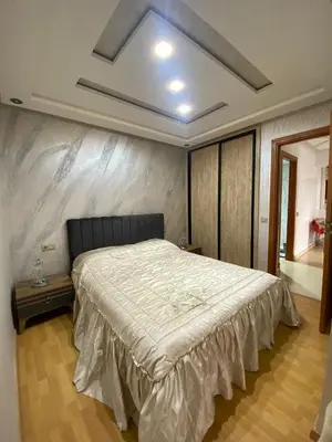 a bedroom with a large bed in a room at Appartement Oasis Beach in Mohammedia