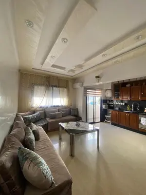 a large living room with a couch and a table at Appartement Oasis Beach in Mohammedia