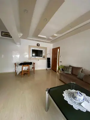 a living room with a couch and a table at Appartement Oasis Beach in Mohammedia