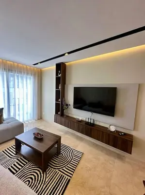 a living room with a large flat screen tv at Studio pivoine 27 CFC à 2mn in Casablanca