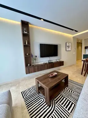 a living room with a television and a coffee table at Studio pivoine 27 CFC à 2mn in Casablanca