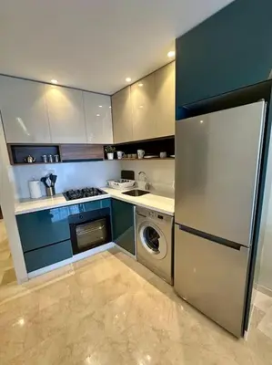 a kitchen with a refrigerator and a washing machine at Studio pivoine 27 CFC à 2mn in Casablanca