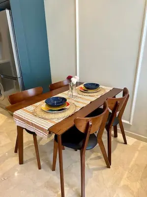 a dining room table with chairs and a table with plates at Studio pivoine 27 CFC à 2mn in Casablanca