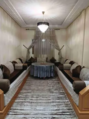 a living room with couches and a table in it at appartement calme in Casablanca