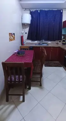 a kitchen with a table and chairs and a sink at appartement calme in Casablanca