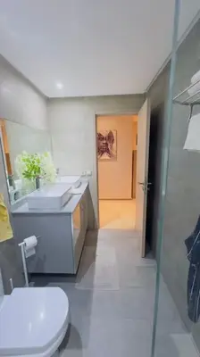 a bathroom with a toilet and a sink and a mirror at Havre de Confort Proche de Tout à 5 min de la Gare in Casablanca