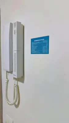 a phone on a wall with a sign on it at Havre de Confort Proche de Tout à 5 min de la Gare in Casablanca