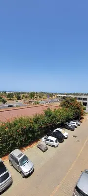 a row of cars parked in a parking lot at Appartement luxueux avec piscine dans une résidence calme in Bouznika