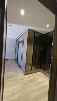 an empty room with glass walls and a wooden floor at Marina casablanca in Casablanca