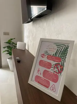 a sign on a counter in a room at Garden Paradise Bouznika Beach Apartment in Bouznika