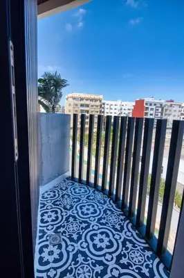 a balcony with a gate and a view of a city at Prestigieux Studio- Vue dégagée in Casablanca