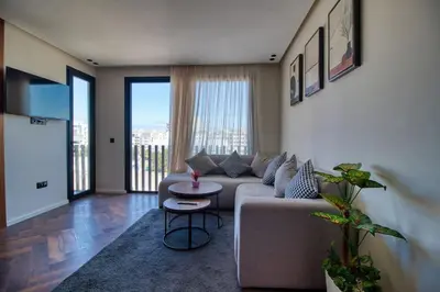 a living room with a couch and a table at Prestigieux Studio- Vue dégagée in Casablanca
