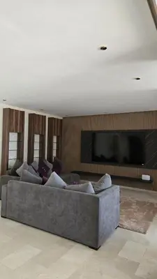 a living room with a couch and a flat screen tv at Casablanca marina in Casablanca