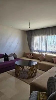 a living room with a couch and a table at Casablanca marina in Casablanca