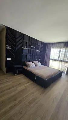 a bedroom with a large bed with a wooden headboard at Casablanca marina in Casablanca