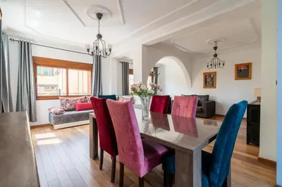 a dining room with a table and chairs at Appartement Cosy Proche du Stade in Rabat