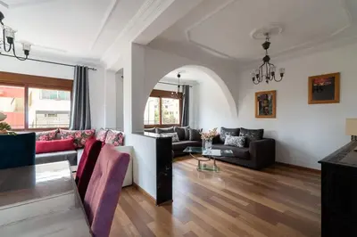a living room with a couch and a table at Appartement Cosy Proche du Stade in Rabat