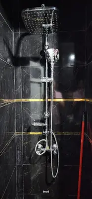 a bicycle in a shower in a black wall at assil hay mohamadi in Casablanca