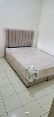 a bed sitting on a tiled floor in a room at assil hay mohamadi in Casablanca