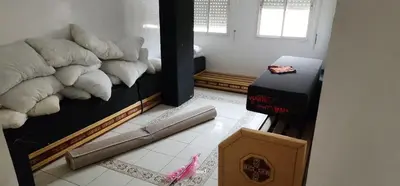 a room with a bed and a baseball bat on the floor at assil hay mohamadi in Casablanca