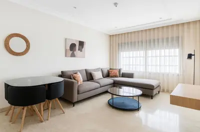 a living room with a couch and a table at Cosy Aparts, 2BR, downtown, near tramway in Casablanca