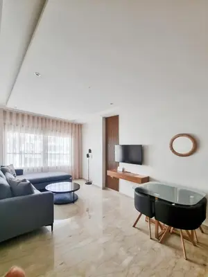 a living room with a couch and a table at Cosy Aparts, 2BR, downtown, near tramway in Casablanca