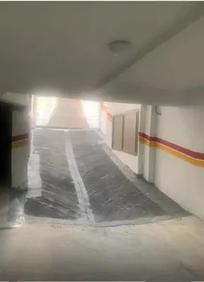 an empty hallway of a building with a white floor at Cosy Aparts, 2BR, downtown, near tramway in Casablanca