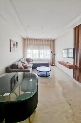 a living room with a couch and a table at Cosy Aparts, 2BR, downtown, near tramway in Casablanca