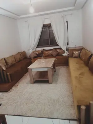 a living room with a couch and a coffee table at Riad Ain Atiq in Temara