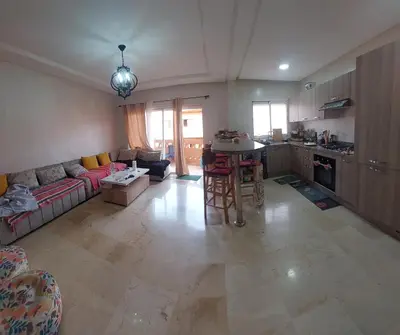 a large living room with a couch and a table at Goulmim in Mohammedia