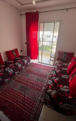 two beds in a room with a window at Appartement vues piscine in Mansouria