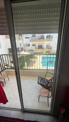 a view of a balcony with a view of a pool at Appartement vues piscine in Mansouria