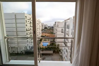 a view of a city from a window at Appartement géant in Rabat