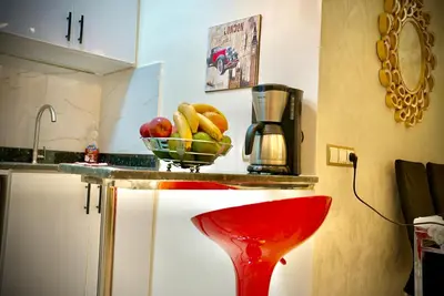 a kitchen with a bowl of fruit on a counter at appartement luxe rabat ville in Rabat