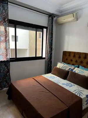 a bed in a room with a window and a bed sidx sidx sidx at Studio meublée free in Casablanca