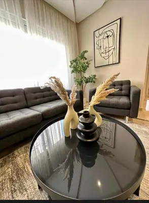 a living room with a glass table with two antlers on it at Studio meublée free in Casablanca