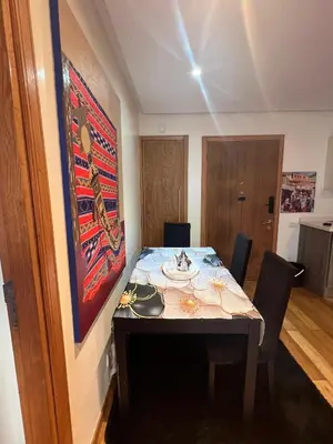 a room with a table with chairs and a painting at Oean view apartment Marina Casablanca in Casablanca