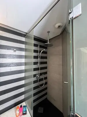 a bathroom with a shower with black and white stripes at Oean view apartment Marina Casablanca in Casablanca