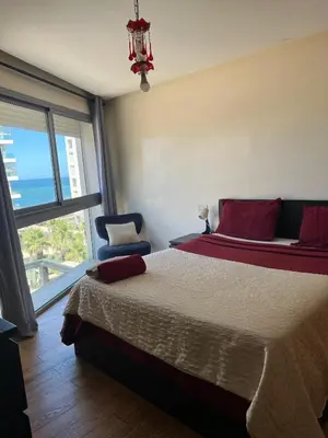 a bedroom with a bed and a large window at Oean view apartment Marina Casablanca in Casablanca