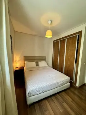 a bedroom with a white bed and a window at Stylish 2 bedroom, in the heart of Casablanca in Casablanca