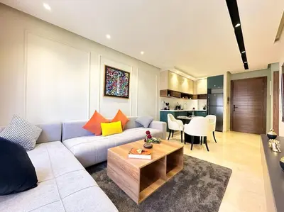 a living room with a couch and a table at Cozy Studio Calypso 10, CFC à 2min, Parking Dispo in Casablanca