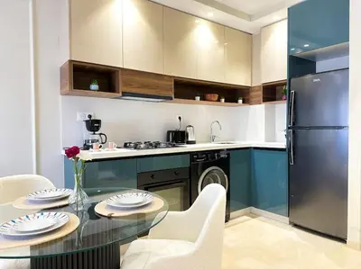a kitchen with a glass table and a refrigerator at Cozy Studio Calypso 10, CFC à 2min, Parking Dispo in Casablanca